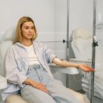 IV hydration for fatigue showing a woman receiving intravenous fluids while resting in a medical clinic.