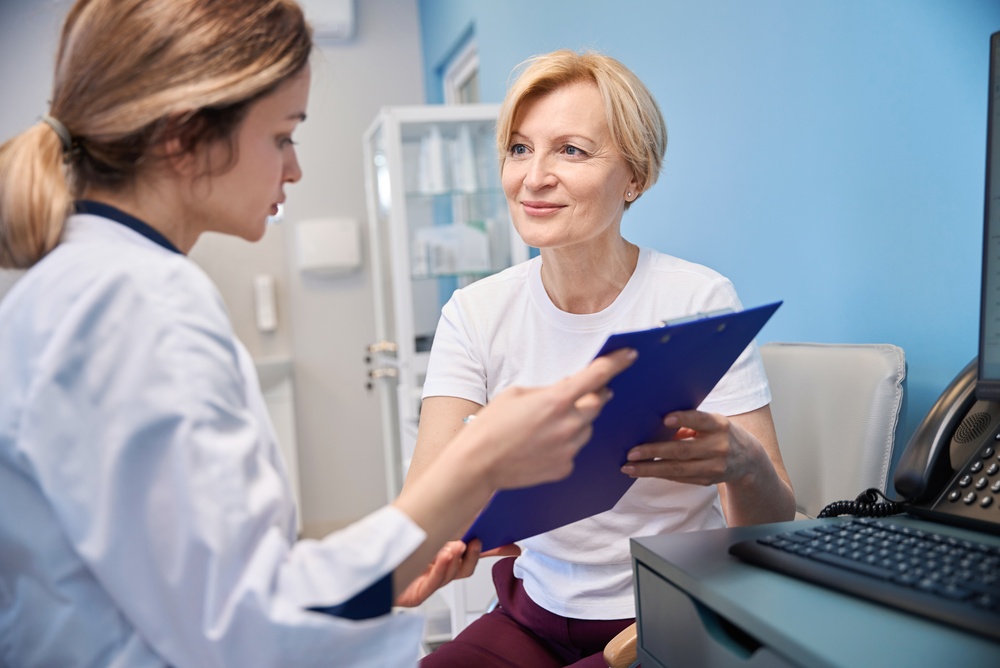 Woman discussing menopause and hormone concerns related to poor sleep with a healthcare provider