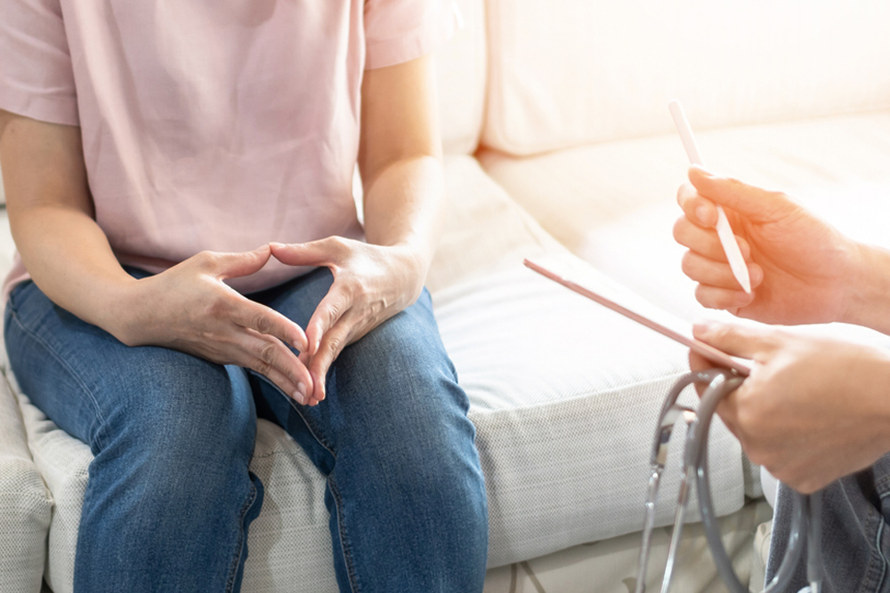 Middle-aged woman discussing menopause symptoms, mood swings, and brain fog with a healthcare provider