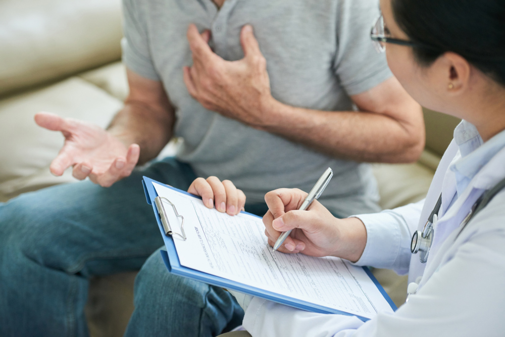 Middle-aged man discussing testosterone deficiency, mood changes, and brain fog with a healthcare provider