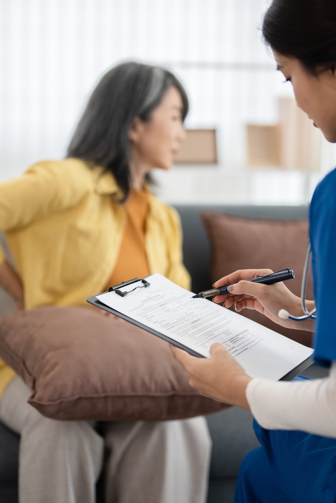 Healthcare provider reviewing mood swings and brain fog symptoms with a female patient during a medical consultation
