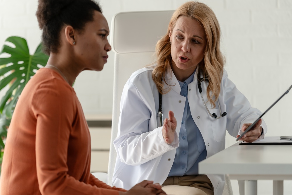 Middle-aged woman discussing mood swings and brain fog symptoms with a healthcare provider