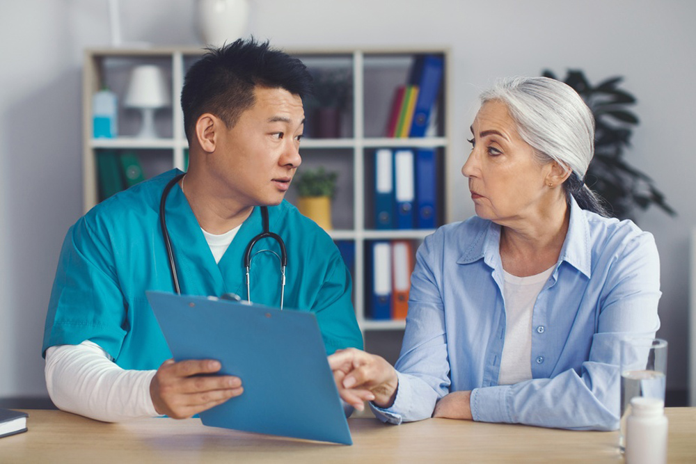 Healthcare provider discussing the onset and daily impact of mood swings and brain fog with a patient