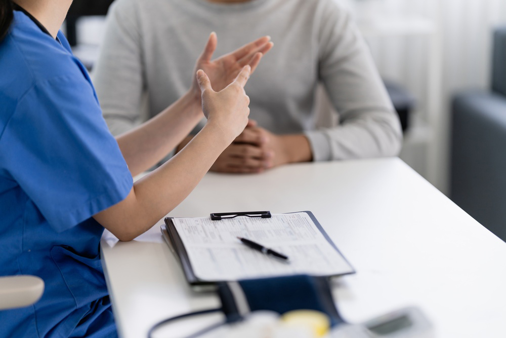 Healthcare provider discussing peptide therapy research and safety considerations with a patient experiencing poor sleep