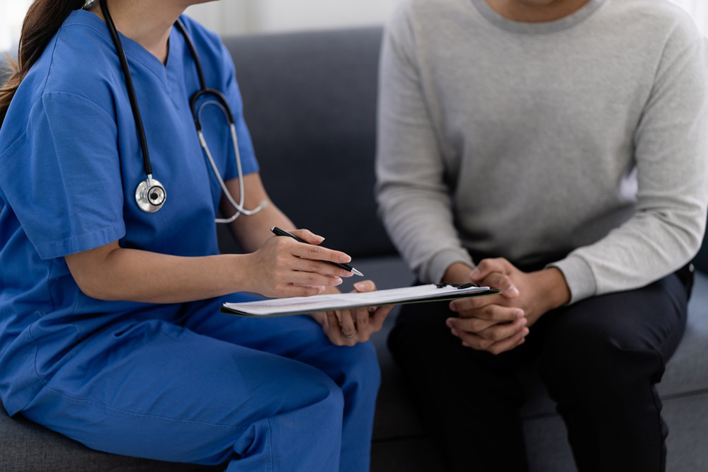 Healthcare provider discussing peptide therapy options, treatment safety, and weight management progress with a patient.