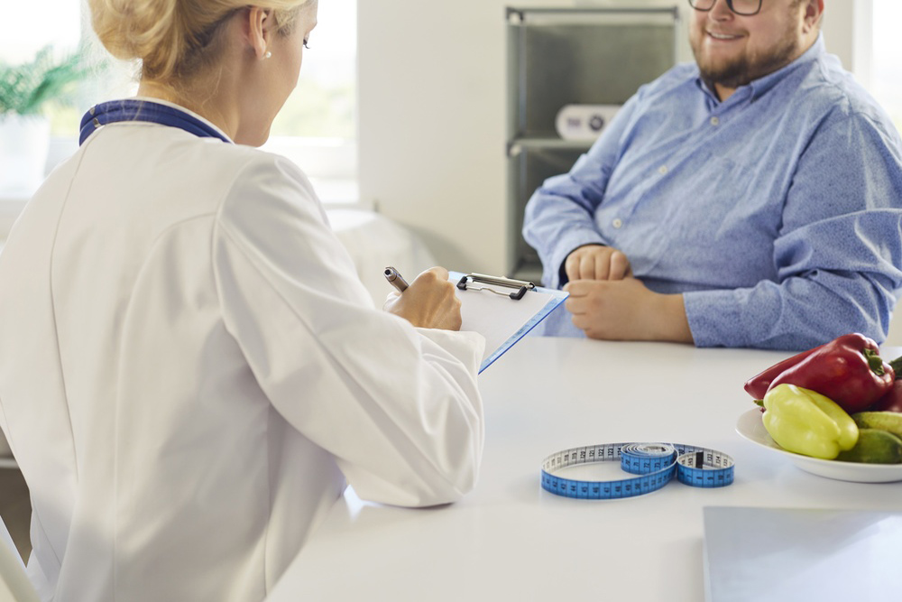 Healthcare provider evaluating stubborn weight gain and body changes during a wellness consultation